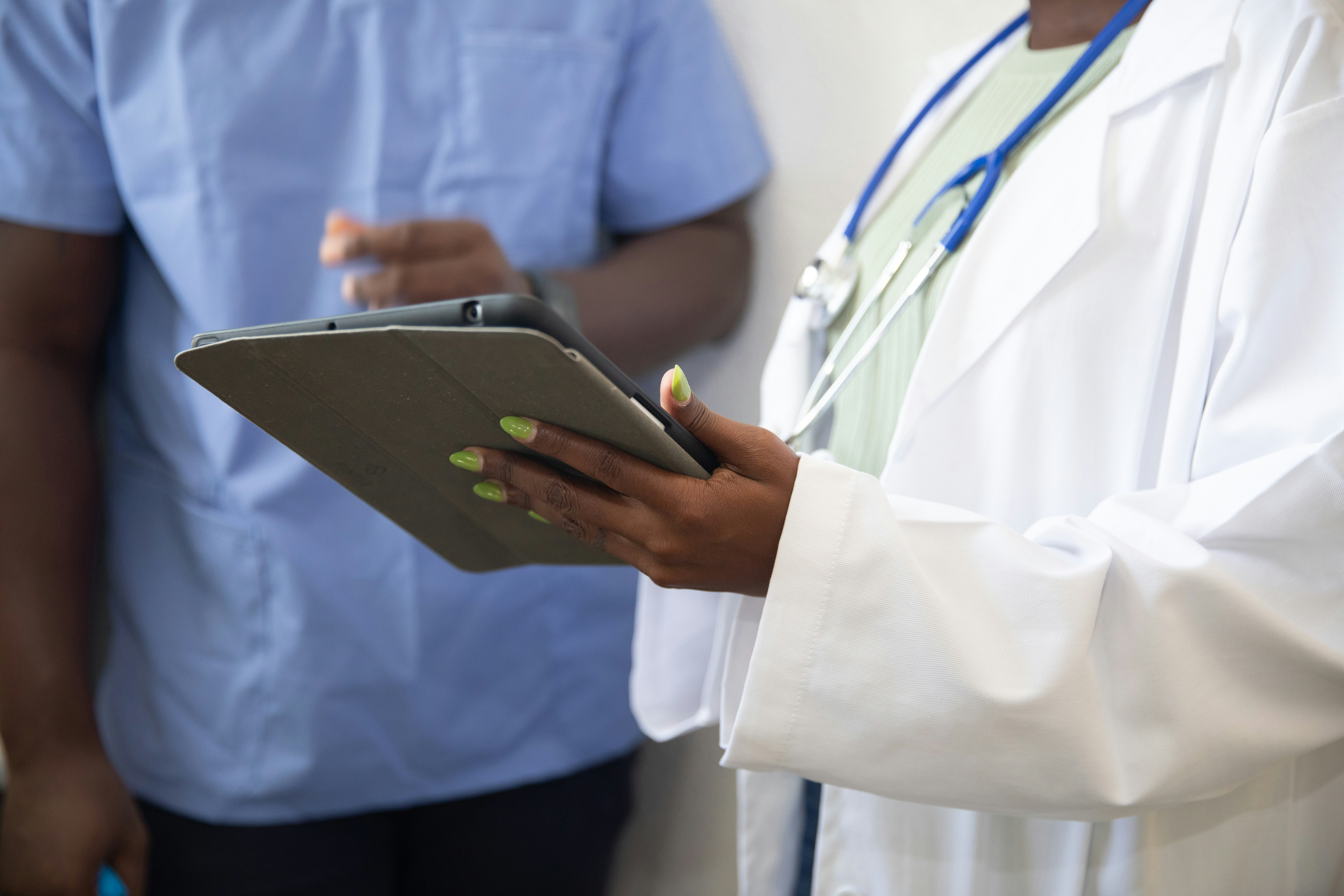 Healthcare professional reviewing patient information on a tablet